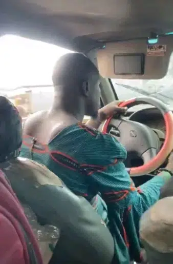 Ibadan driver causes buzz as he is seen rocking a woman's blouse while working