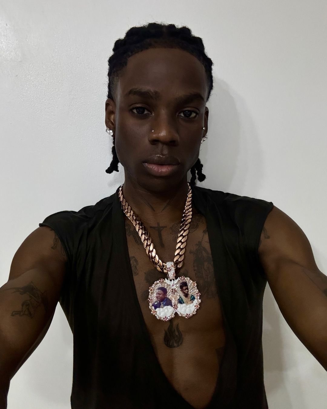 Rema pays tribute to father and late brother with new custom-made neckpiece