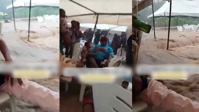 "If you chop finish, be ready to swim" – Party guests r!sk it all for jollof rice while celebrating in the middle of a fl00d (WATCH)