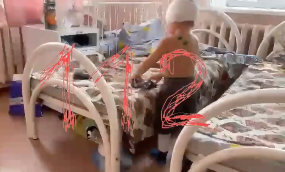 Vova in hospital playing with his toys despite the horrific ordeal he faced