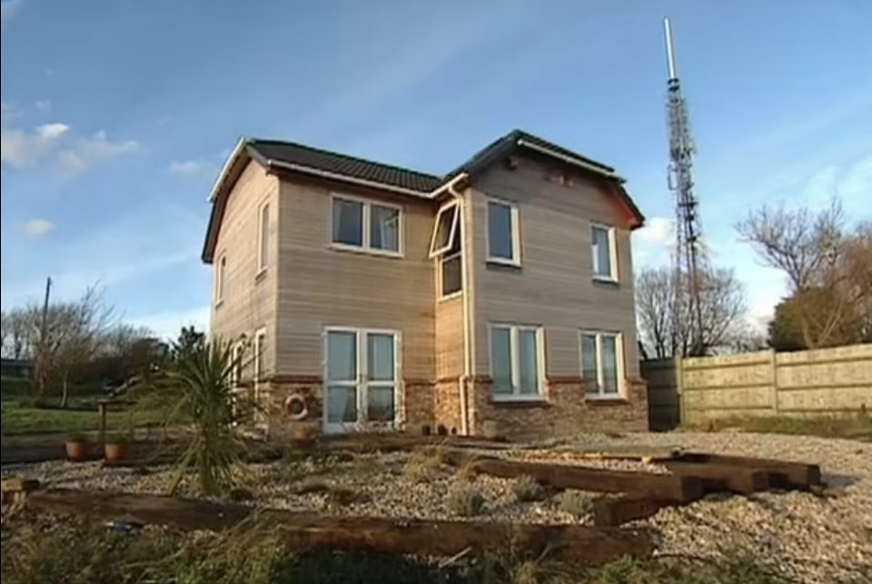 The house (pictured in 1999) was left unfinished, with a messy garden and bare exterior