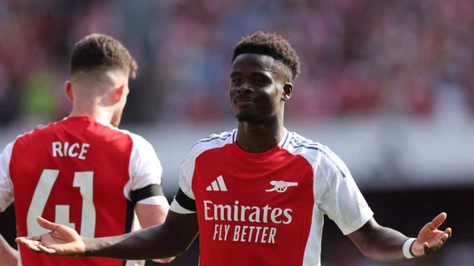 Bukayo Saka celebrates after scoring for Arsenal in their Premier League opener.