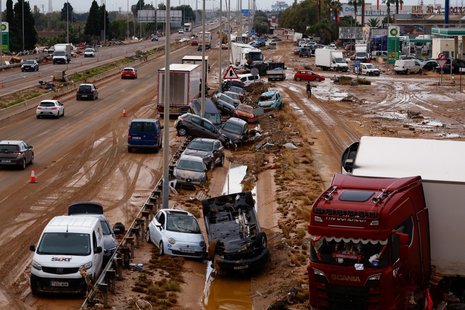 A destroyed road filled with wrecked cars n Alfafar, in Valencia