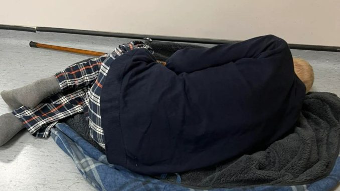 Harrowing picture shows pensioner with pneumonia, 75, curl up on dressing gown on hospital FLOOR in 12-hour wait for bed