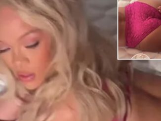 Rihanna has bum lathered in cream as she lies on bed in pink lace lingerie