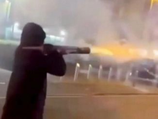 Watch shocking moment hooded man with ROCKET LAUNCHER shoots fireworks at people in busy city centre