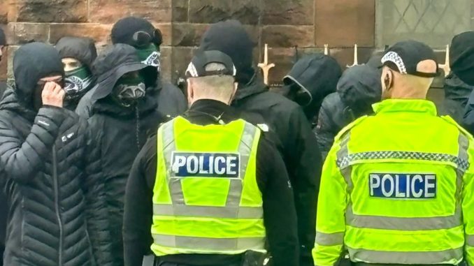 Balaclava-clad protesters 'guard Catholic Church' amid passing Loyalist march