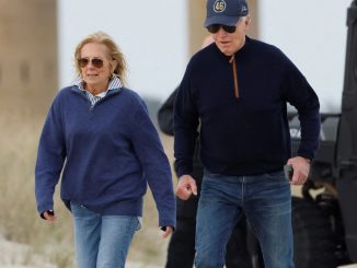 Moment Joe Biden wobbles and stumbles on sandy beach as Jill struggles to keep him up during day out in Delaware