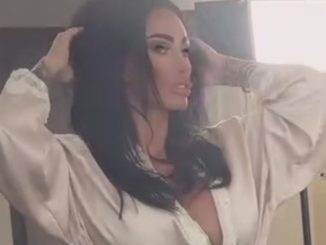 Katie Price risks slipping out of silk plunging gown as she poses up a storm at a photoshoot