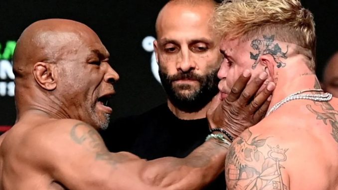 Mike Tyson SLAPS Jake Paul before being pulled apart by security in chaotic weigh in before controversial Netflix fight