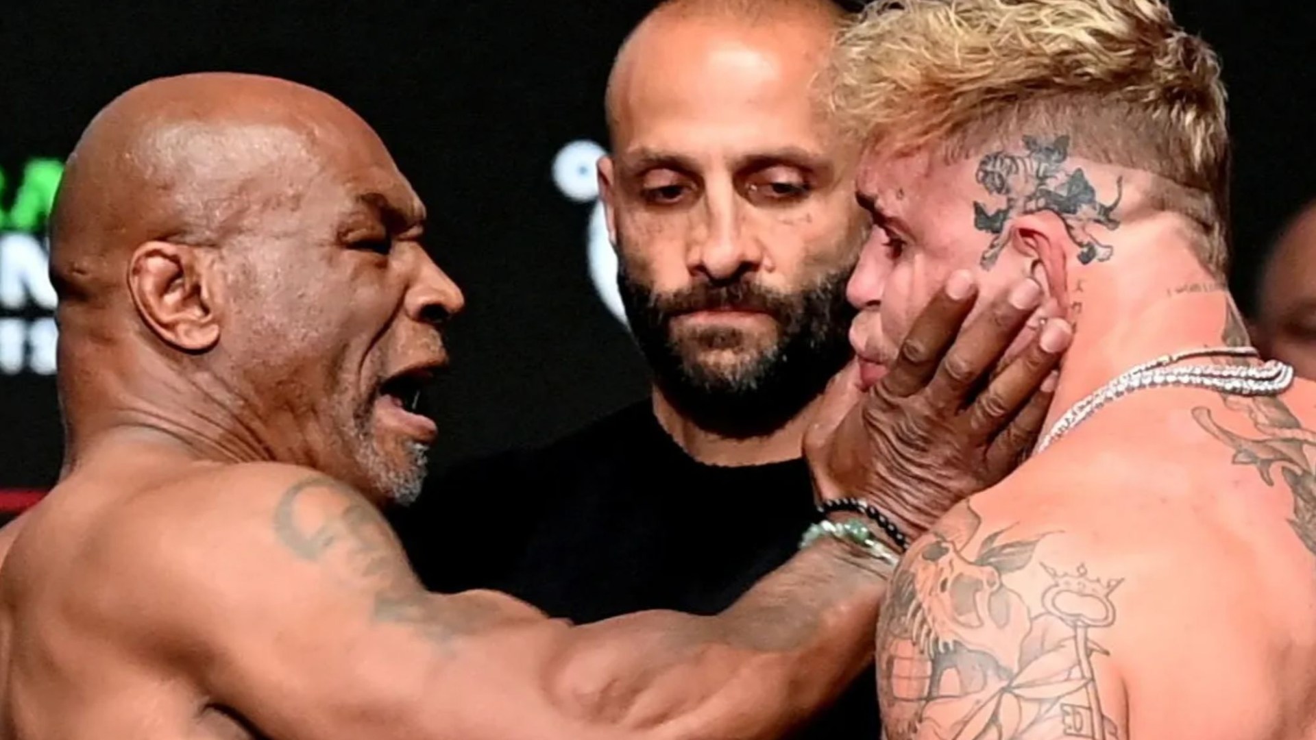 Mike Tyson SLAPS Jake Paul before being pulled apart by security in chaotic weigh in before controversial Netflix fight