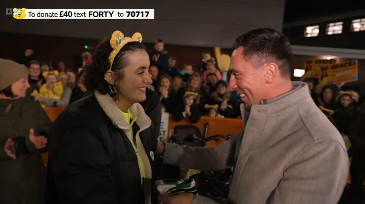 Grace is delighted to receive the jersey from Scott Brown