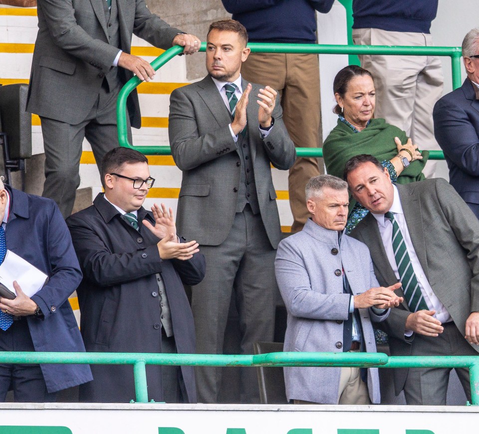 Derek White (glasses, dark overcoat) in stand with CEO Ben Kensell