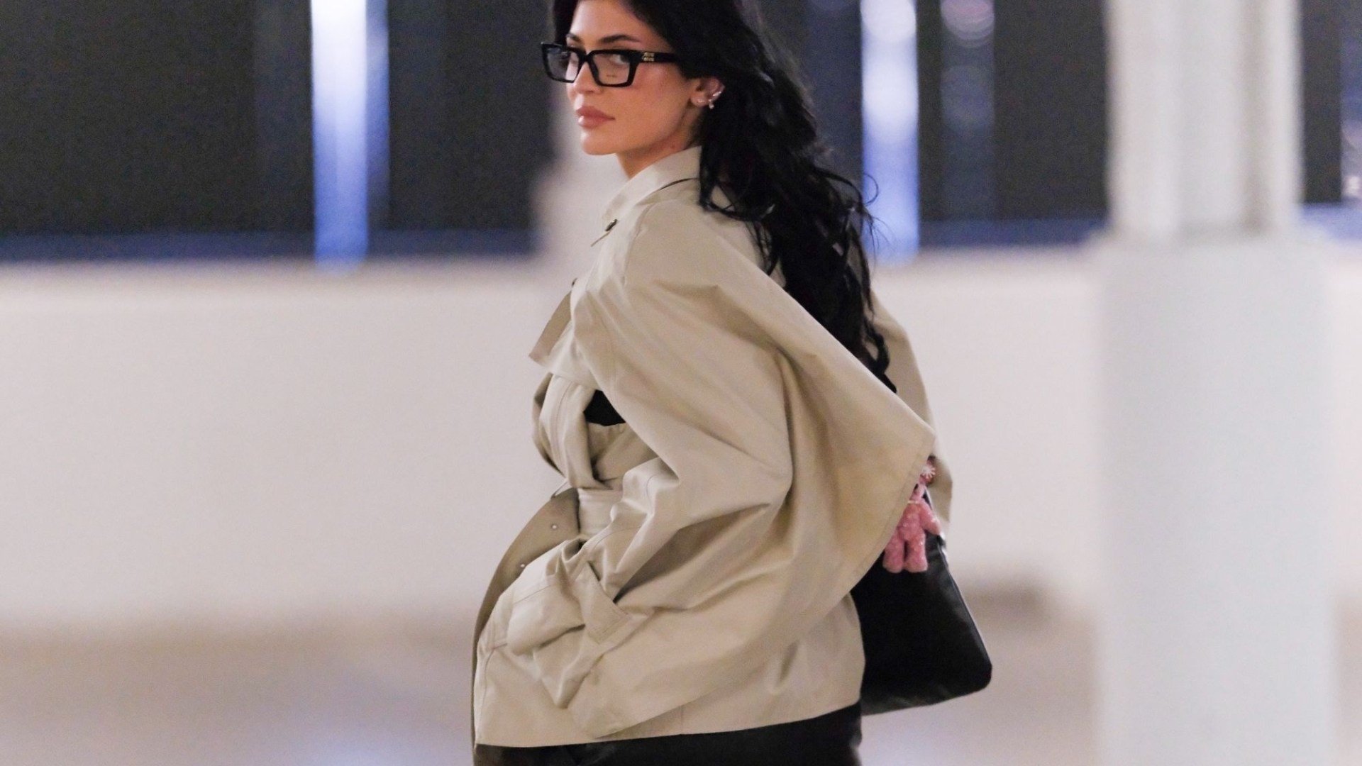 Kylie Jenner looks incredible as she's spotted out in black boots, a trench coat and glasses