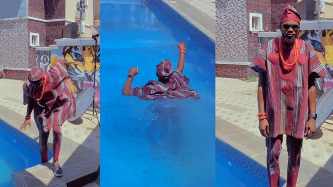 "Àgbada turn life jacket" – Hilarious moment man f@lls into the swimming pool during a photoshoot (WATCH)