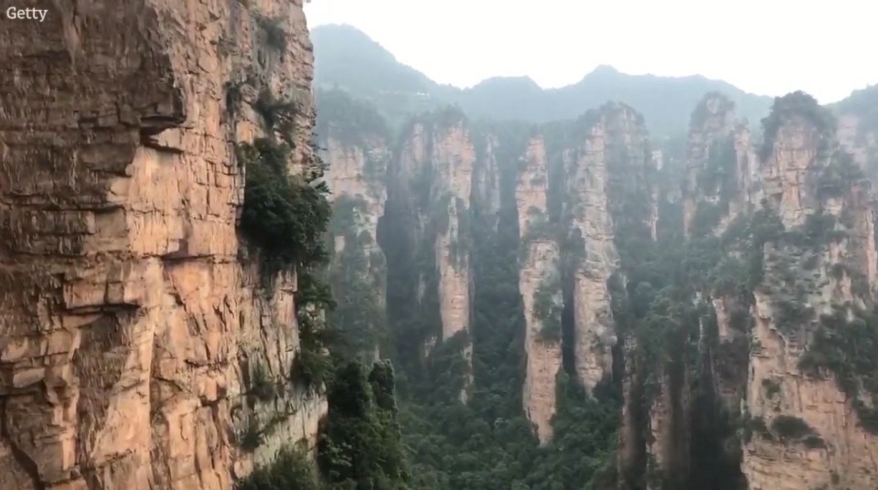 The view from inside the elevator looks out onto sandstone pillars