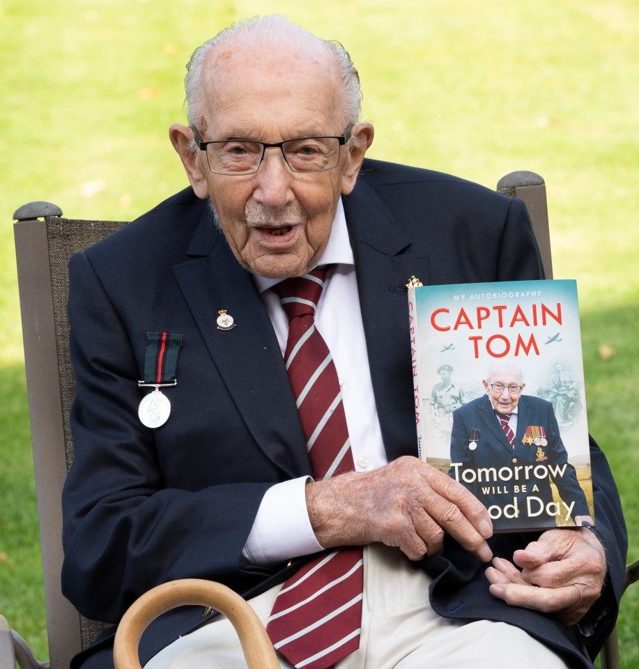 The late Captain Tom Moore with a copy of his autobiography