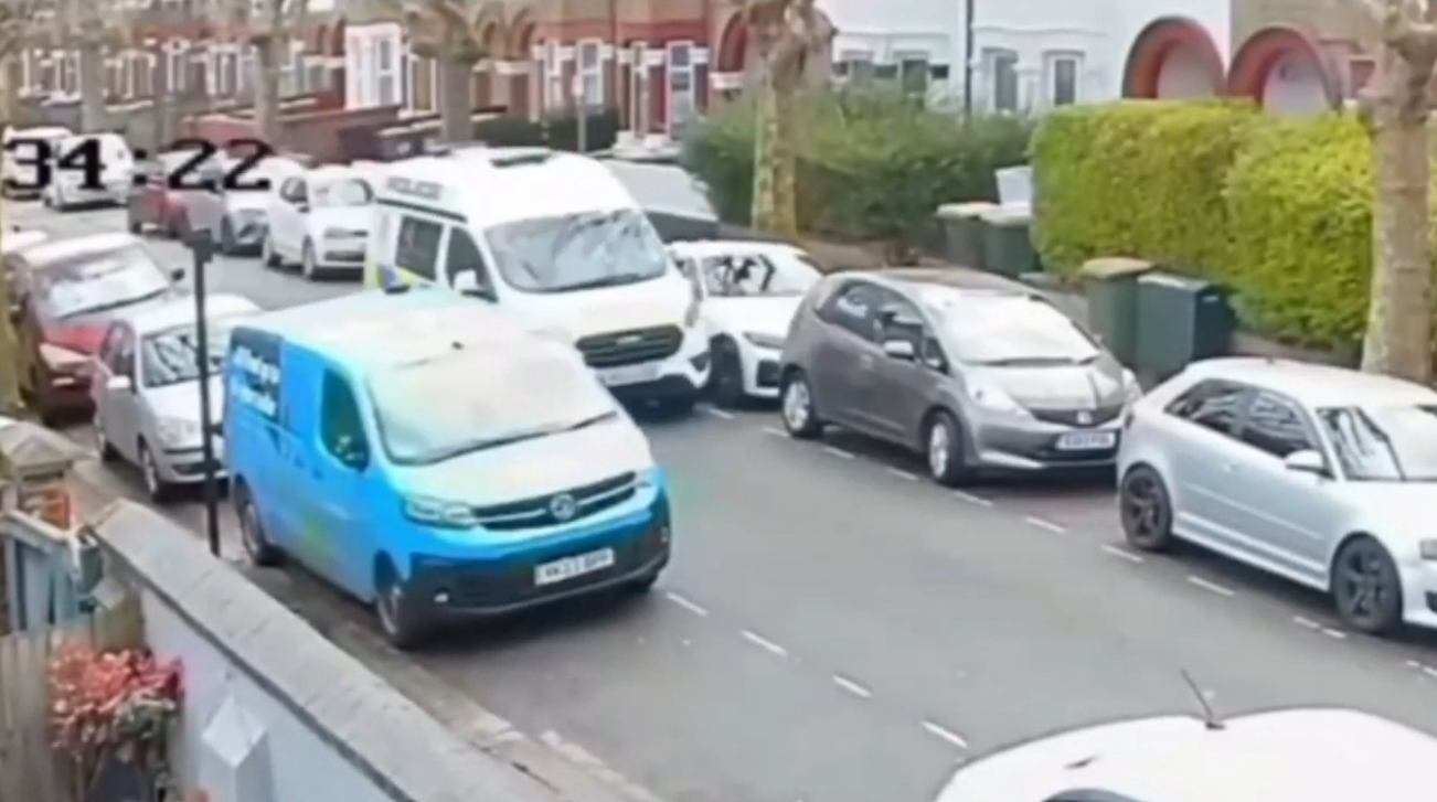 Shocking moment cop smashes van into parked BMW while EATING behind wheel - only to carry on driving seconds later