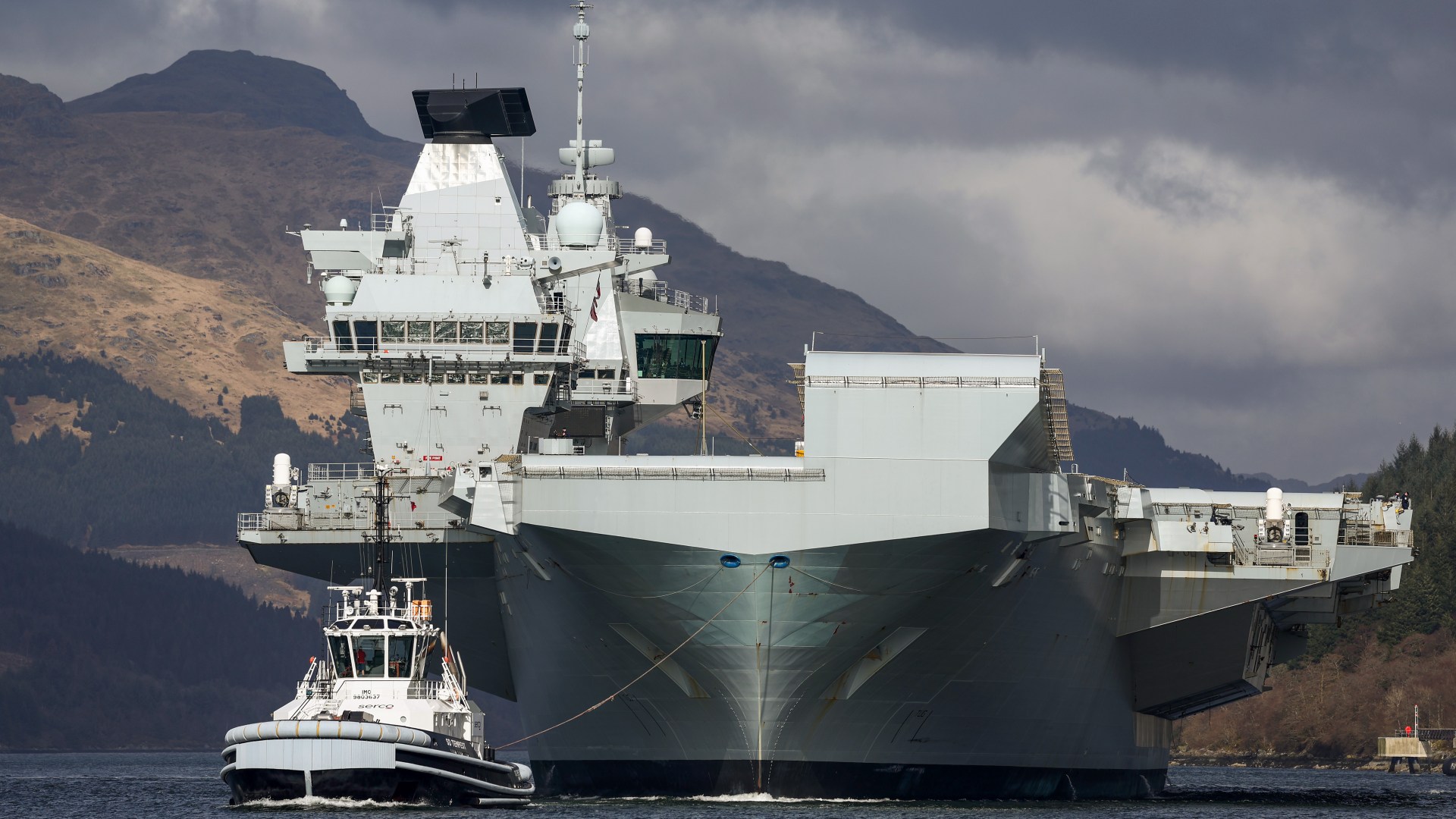 Unidentified drone 'follows' UK's £3bn flagship aircraft carrier - days after fleet of devices fly over three RAF bases