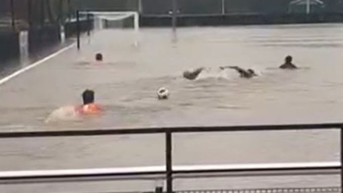 Non-league stars go SWIMMING on their pitch as entire stadium covered in water as Storm Bert wreaks havoc