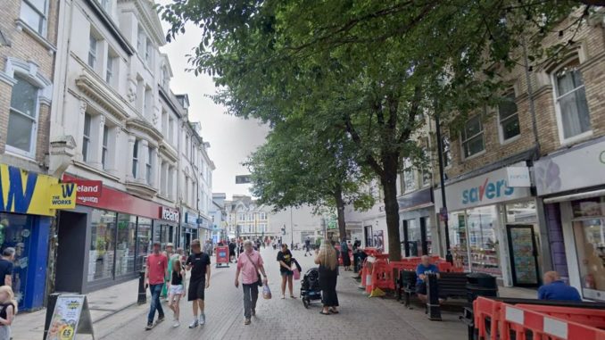 Man in 30s fighting for his life after 'corrosive substance' attack in seaside town centre as 3 men & 2 women arrested