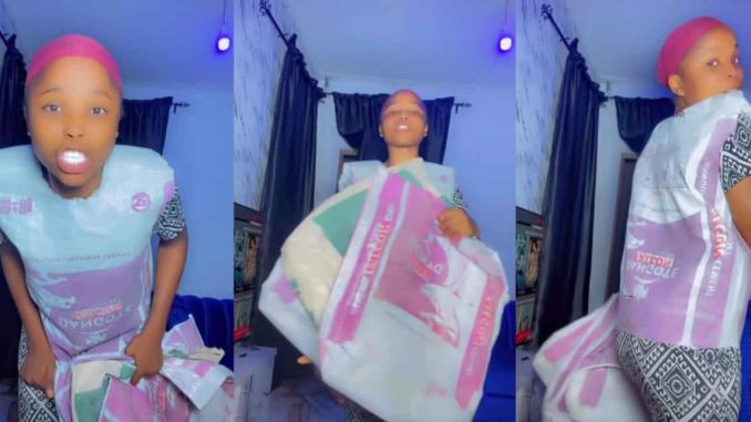 Lady advertises Dangote cement bags as 'party' and 'couples wear'