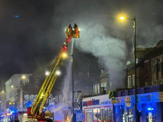 Flames engulf block of flats sending smoke billowing into sky as 100 firefighters rush to tackle inferno