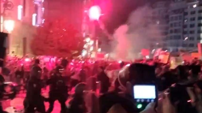 Horror moment riot cops clash with furious protesters hurling flares in Spain as anger grows over floods that killed 220