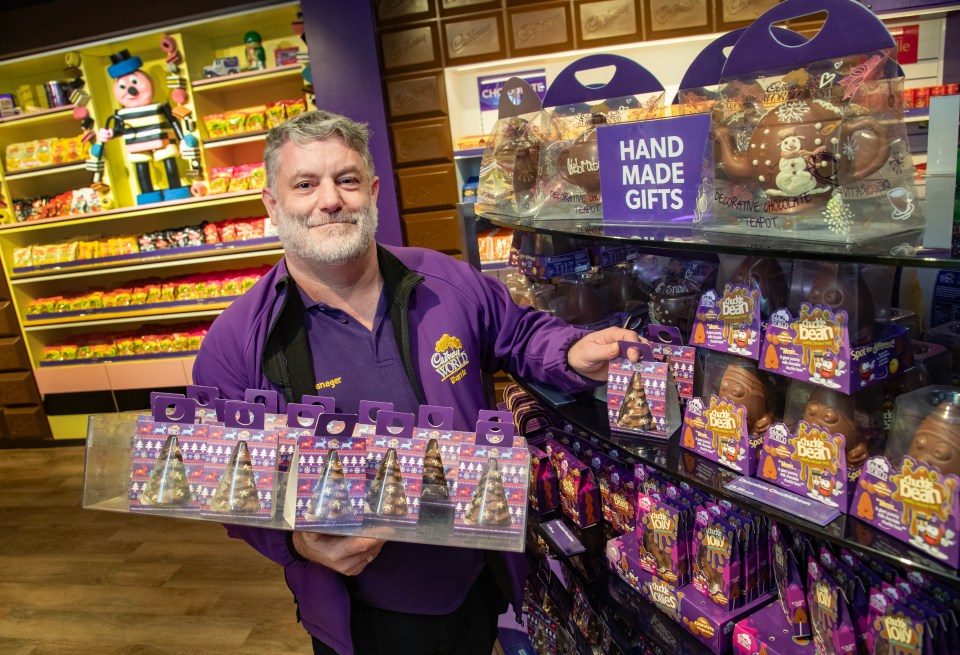 Retail manager Barrie Oldridge puts the handmade chocolate on the shelf