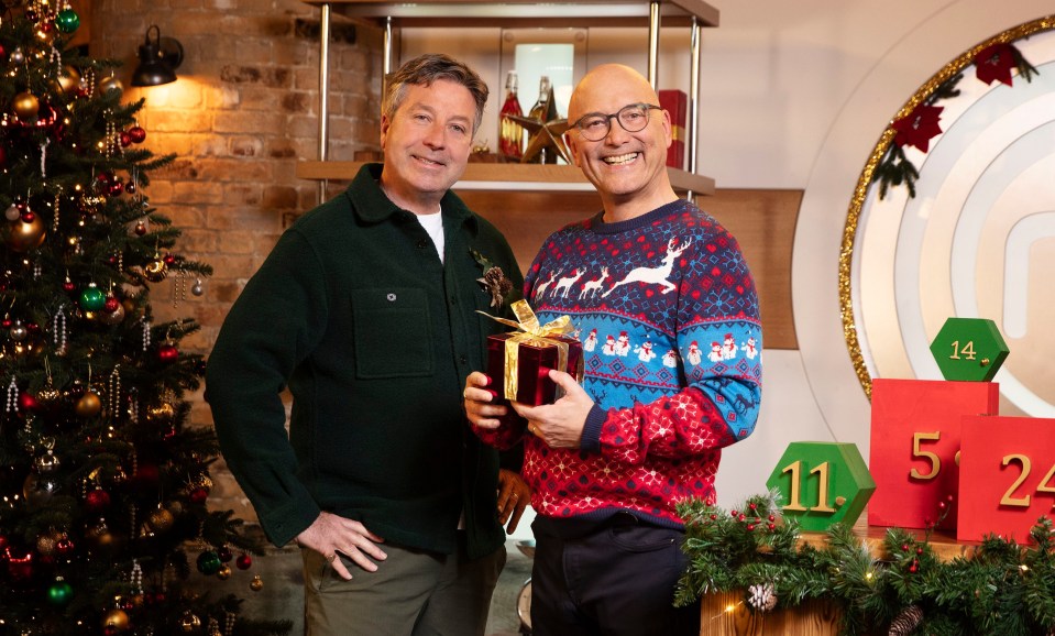 Wallace and partner John Torode grinning in Christmas jumpers on promotional pics for the semi-final of MasterChef: The Professionals