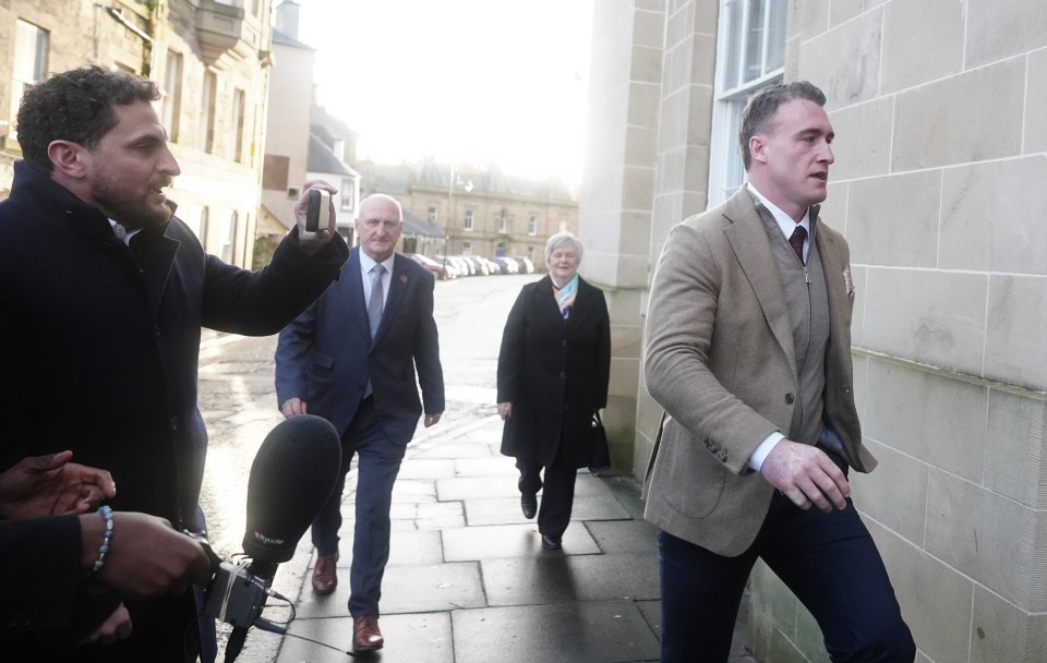 Red-faced Hogg was swarmed by reporters as he left court