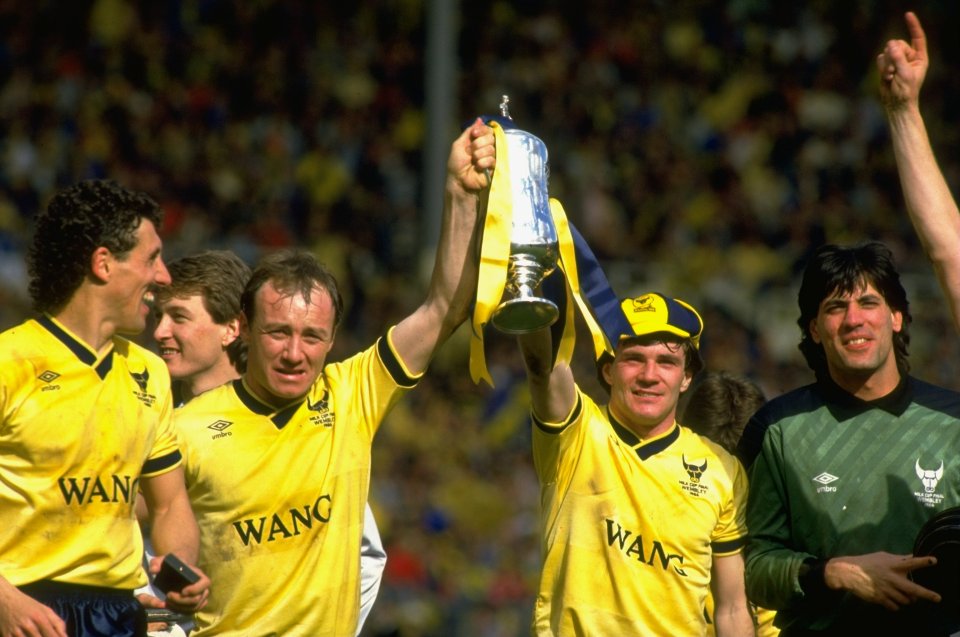 Houghton, second from right, and David Langan of Oxford United lift the League Cup after beating QPR 3-0 at Wembley