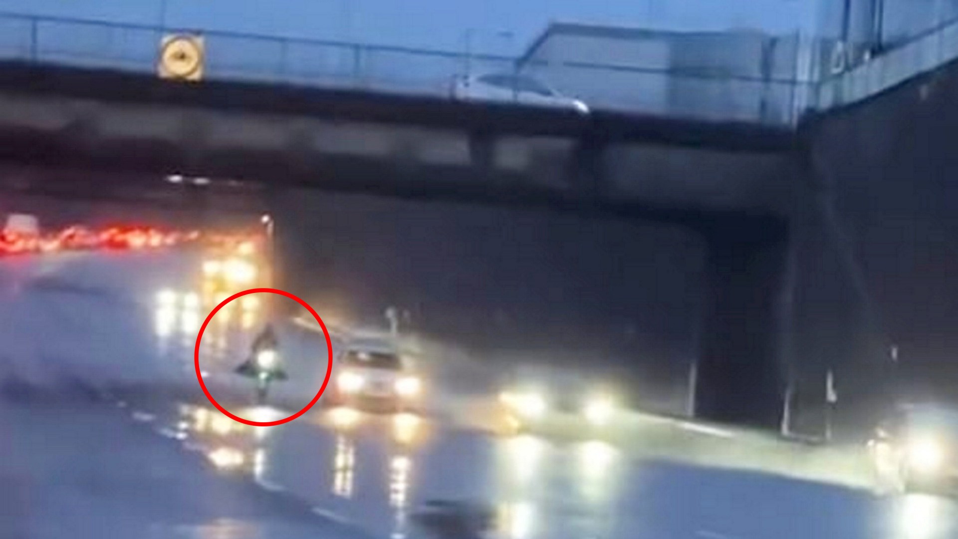 Moment masked idiot risks their life riding 10mph e-scooter on MOTORWAY during Storm Darragh