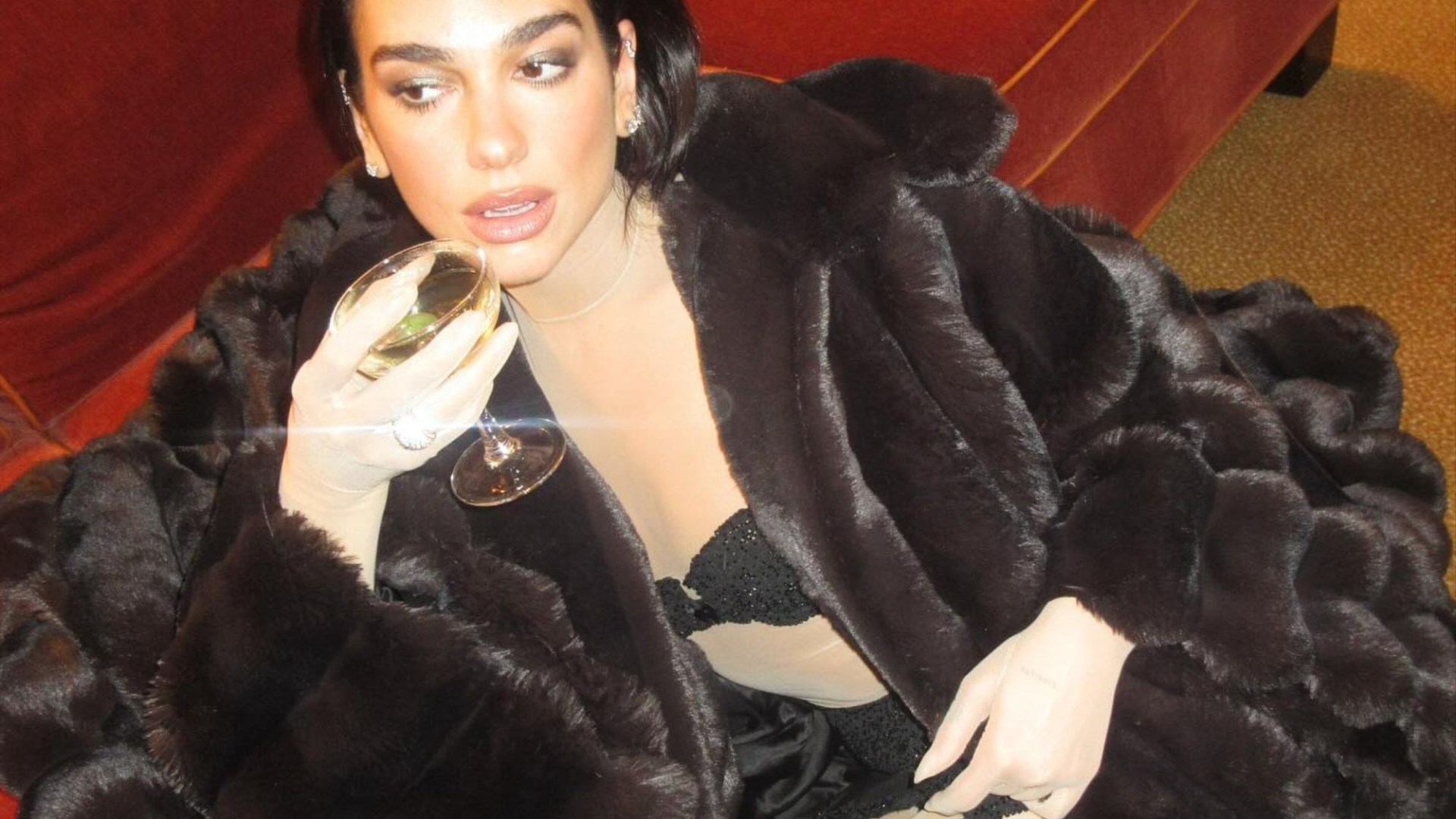 Dua Lipa sizzles as she strips off to stockings and fur coat