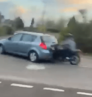 The bike then struck the back of a car