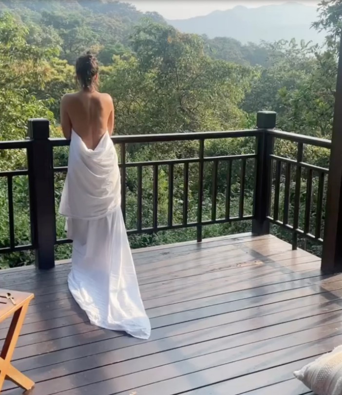 The actress went topless on her balcony as she took in the breath-taking view